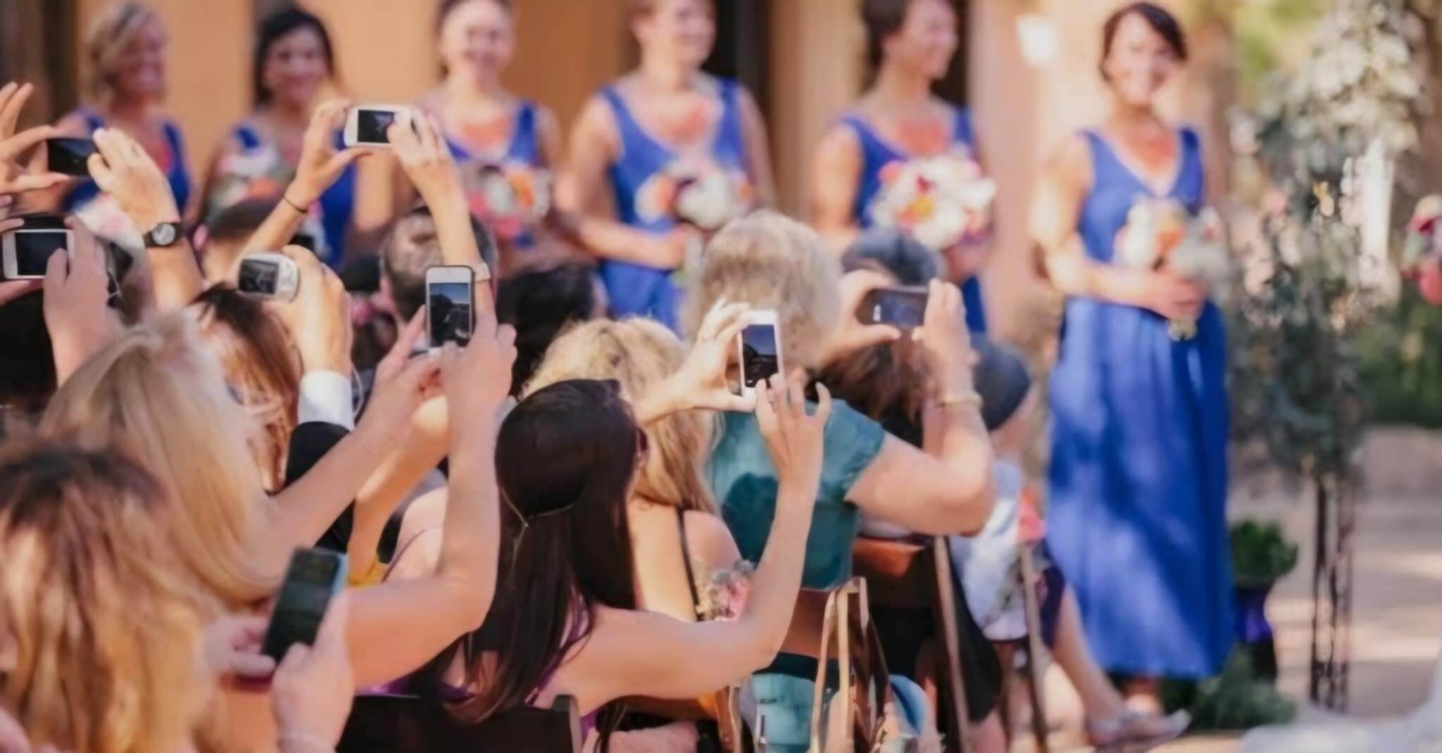 guest with cameras at wedding ceremony